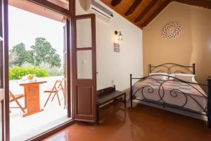 a bedroom with a bed and a balcony at The old town Neighbourhood in Rhodes Town