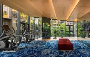 a gym with treadmills and exercise equipment in a building at PRIME TOWN Phuket Resort & Wellness in Ban Rangeng