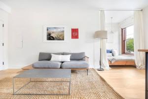 a living room with a couch and a table at Annabelle 2B - City Views near City Market and River in Savannah