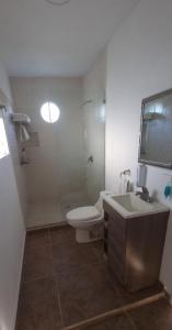a bathroom with a toilet and a sink and a shower at Comunidad Regenerativa Ixtapan de la Sal in Ixtapan de la Sal