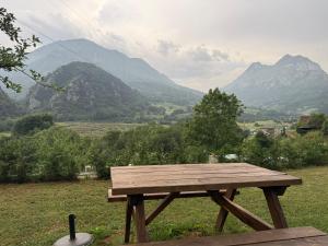a wooden picnic table with a view of mountains at Mirador del Oso in Proaza