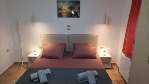 a bedroom with a bed with two towels on it at SpoonLand in Néa Koútali