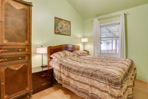 a bedroom with a bed with a dresser and a window at Screened Porch and Fire Pit Cabin Near Bethel Woods in Mongaup Valley +17 photos