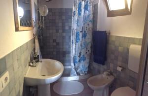 a small bathroom with a sink and a toilet at La Medusa in San Teodoro