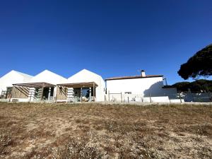 a group of white buildings in a field at Meco Lodge Deep Blue in Sesimbra