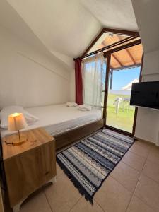 a bedroom with a bed and a large window at Sahil Apart in Datca
