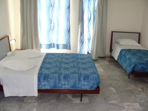 Posteľ alebo postele v izbe v ubytovaní Rodon Hotel