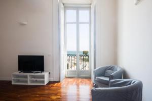 a living room with a television and a chair at B&B Palazzo Mirelli in Naples +49 photos
