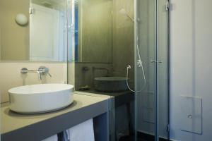 a bathroom with a sink and a glass shower at Palazzo Mirelli in Naples +43 photos