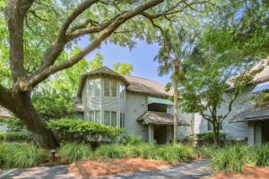 an old house with trees in front of it at Lazy Lagoon in Kiawah Island