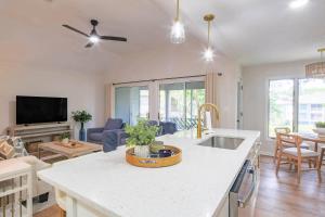 a kitchen and living room with a sink and a counter at Lazy Lagoon in Kiawah Island