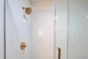 a shower stall with a glass door and a shower at Lazy Lagoon in Kiawah Island