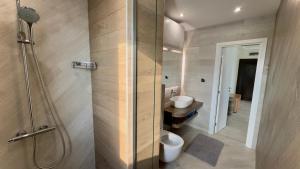a bathroom with a shower with a toilet and a sink at Апартаменти и студия в комплекс Акротирия in Nesebar +246 photos