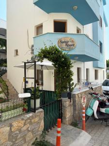 a building with a scooter parked in front of it at Sahil Apart in Datca