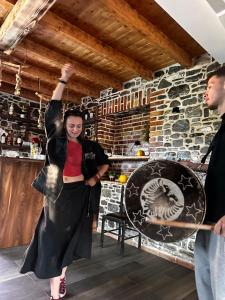 a woman with her arm in the air in a bar at Nia's Farm in Librazhd +77 photos