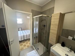 a bathroom with a shower and a toilet and a sink at Appartamento Paganini Modena in Modena