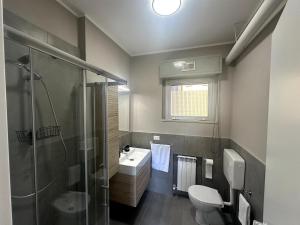 a bathroom with a shower and a sink and a toilet at Appartamento Paganini Modena in Modena +11 photos