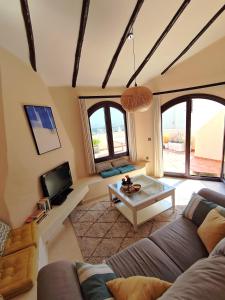 a living room with a couch and a table at Casa de Ensueño - exklusive Villa mit 3 Schlafzimmern, 3 Bädern, 4 Terrassen mit Panoramaausblick in Atamaría