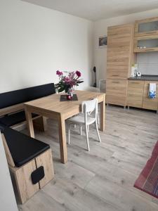 a dining room with a wooden table and chairs at Pod Kyčarou in Čabalovce +9 photos