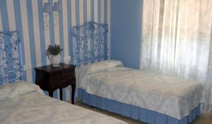 Posteľ alebo postele v izbe v ubytovaní Hostal Emilia