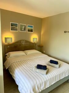 a bedroom with a bed with two towels on it at Les Jardins d'Opale 1 in Le Touquet-Paris-Plage +22 photos