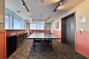a conference room with a ping pong table in it at InfinityNest Chic downtown escape stunning views in Calgary