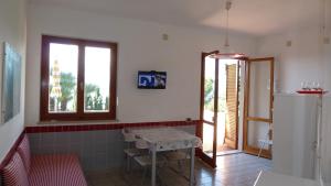 a small kitchen with a table and a window at Residence Cala dei Peducelli in Capoliveri