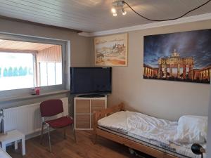 TV a/nebo společenská místnost v ubytování Neumünster Tati