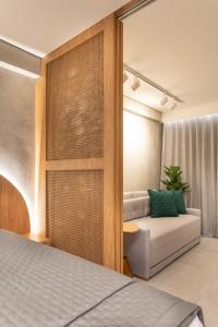 a living room with a bed and a couch at FLAT pé na areia frente mar com vista incrível, HYDE PARK 103 in João Pessoa