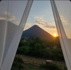 a view of a mountain from a window with the sunset at Holiday Residence Šehić in Visoko