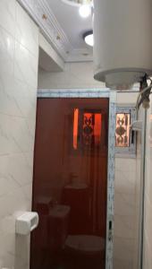 a bathroom with a toilet and a sink at Résidence REHA, appart 2CH in Bafoussam +2 photos