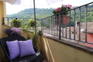 a purple pillow on a chair on a balcony at La Casa del Borgo Antico in Spoleto