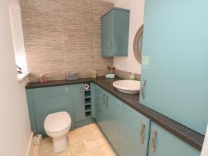 a bathroom with a toilet and a sink at Guildford Farmhouse in Ryde