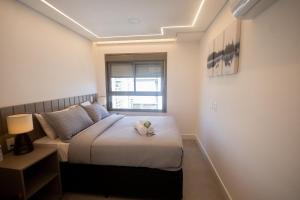 une petite chambre avec un lit et une fenêtre dans l'établissement Apartamentos de luxo Campo belo perto do aeroporto, à São Paulo 119 autres photos