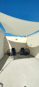three chairs sitting on top of a building at Le Case Di Tufo- Casa del sole in Favignana