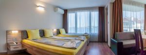 a bedroom with a bed with a child on it at Guest House Karamihalevi in Sozopol