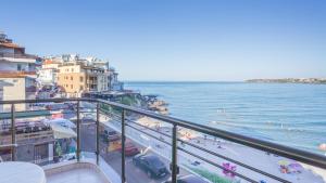 a balcony with a view of a beach and the ocean at Guest House Karamihalevi in Sozopol