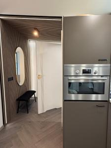 a kitchen with a stainless steel stove and a door at Ásgarður Apartments in Keflavík