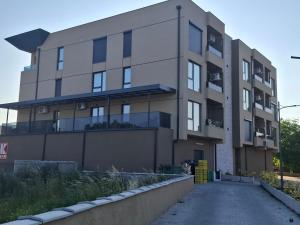 an apartment building with a driveway in front of it at GOLD Apartment-Airport in Petrovec