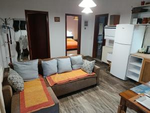 a living room with a couch and a bedroom at Beautiful nearby beach house with garden, private pool and large yard in Sidari