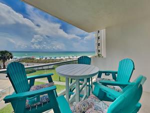 a table and chairs on a balcony with a view of the beach at Regency Towers #302 West in Pensacola Beach