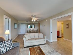 a living room with a couch and a ceiling fan at Regency Towers #302 West in Pensacola Beach