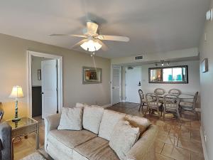 a living room with a couch and a table at Regency Towers #302 West in Pensacola Beach +25 photos