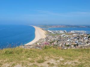 a view of a beach with a city and the ocean at Kelston Guest House in Weymouth