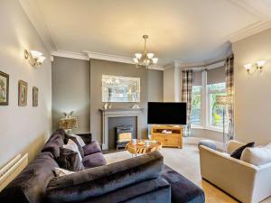 a living room with a couch and a tv at 4 Bed in Llandudno 95235 in Llandudno