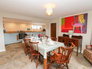 a dining room with a white table and chairs at Rosemary Cottage in Leyburn +23 photos