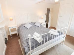 a bedroom with a bed and two night stands at Rosemary Cottage in Leyburn