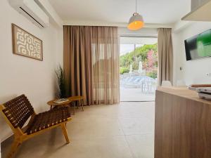 a living room with a bench and a table at Zorbas Family Villas in Skiathos Town