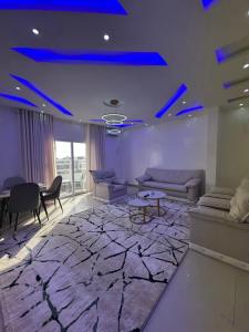 a living room with blue lights on the ceiling at GLC Appartement in Nouakchott