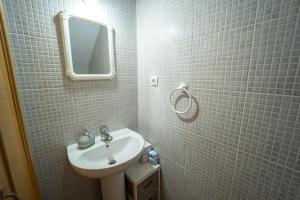 a white bathroom with a sink and a mirror at Adosado con piscina cerca de Castellón y Benicàssim a 10 min andando de la playa in Almazora +24 photos